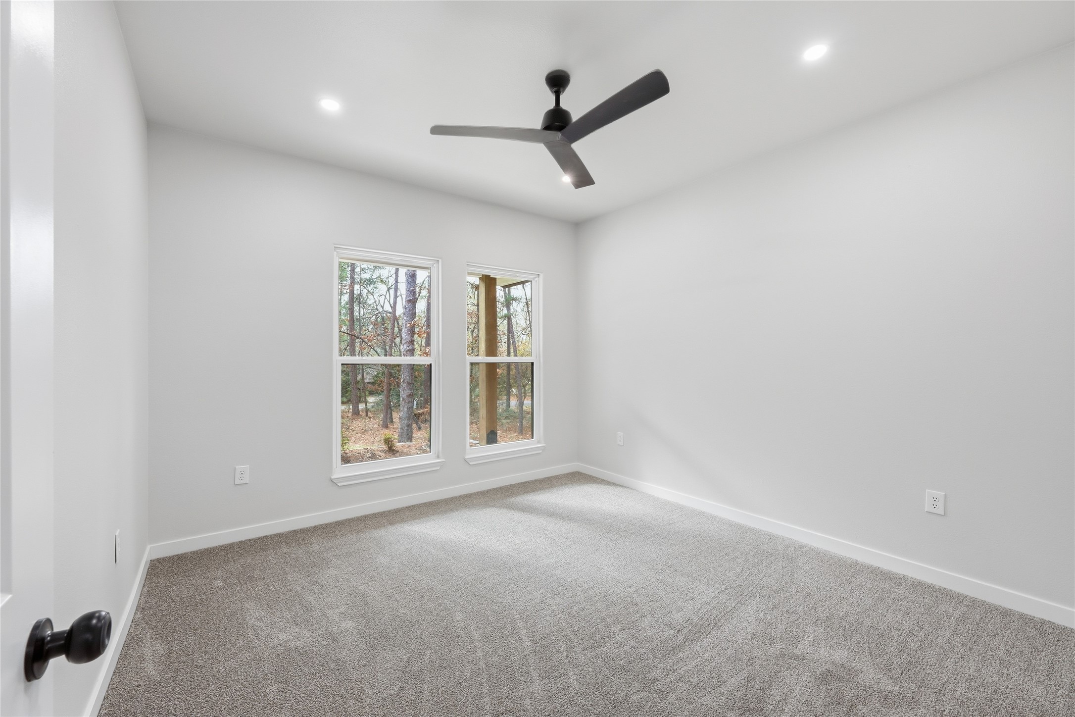 235 Dogwood Road Brookeland, TX 75931 - Photo 25 of 35 an empty room with a ceiling fan and windows