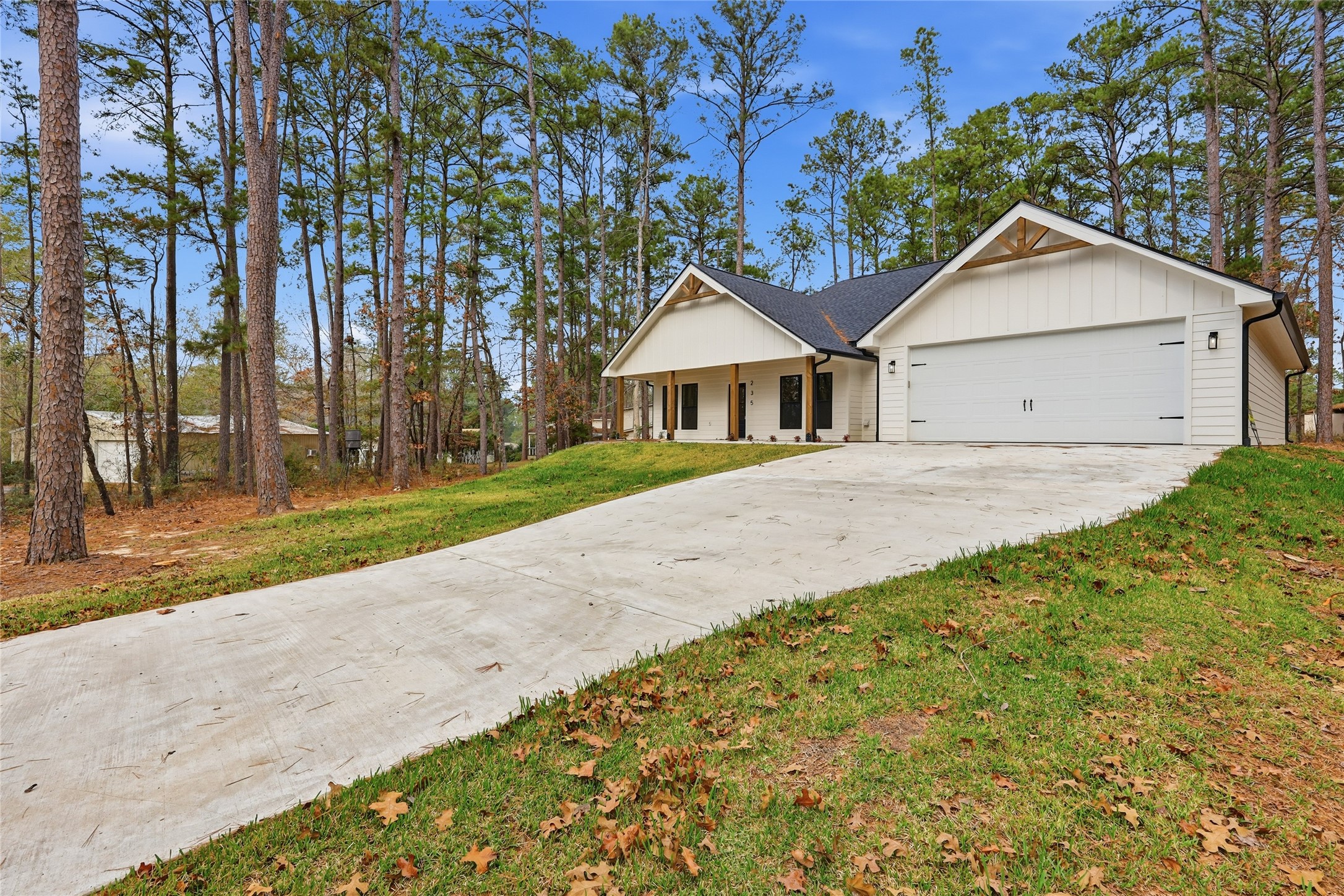 235 Dogwood Road Brookeland, TX 75931 - Photo 31 of 35 a front view of a house with a yard and trees