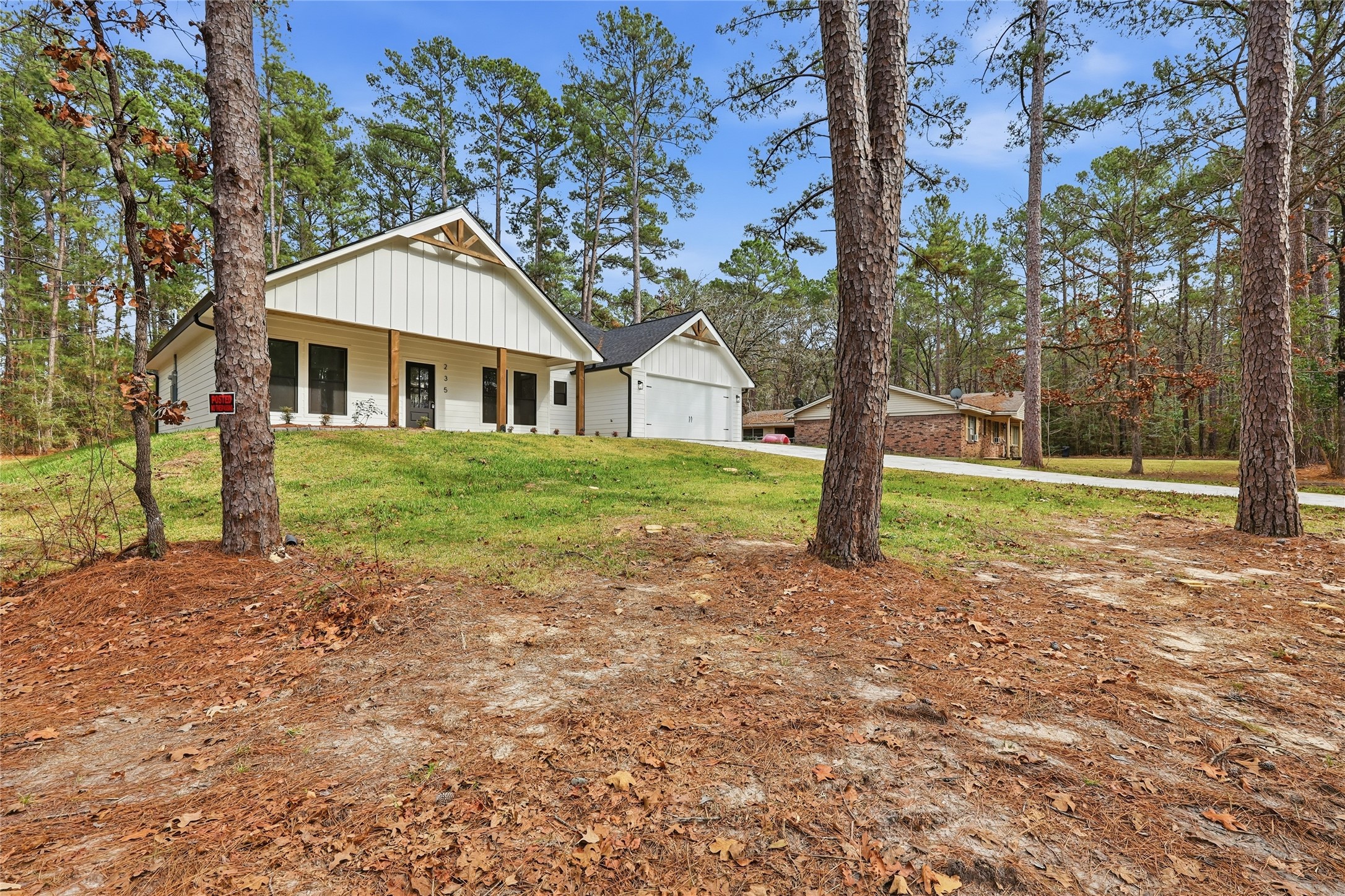 235 Dogwood Road Brookeland, TX 75931 - Photo 32 of 35 a front view of a house with a yard and trees