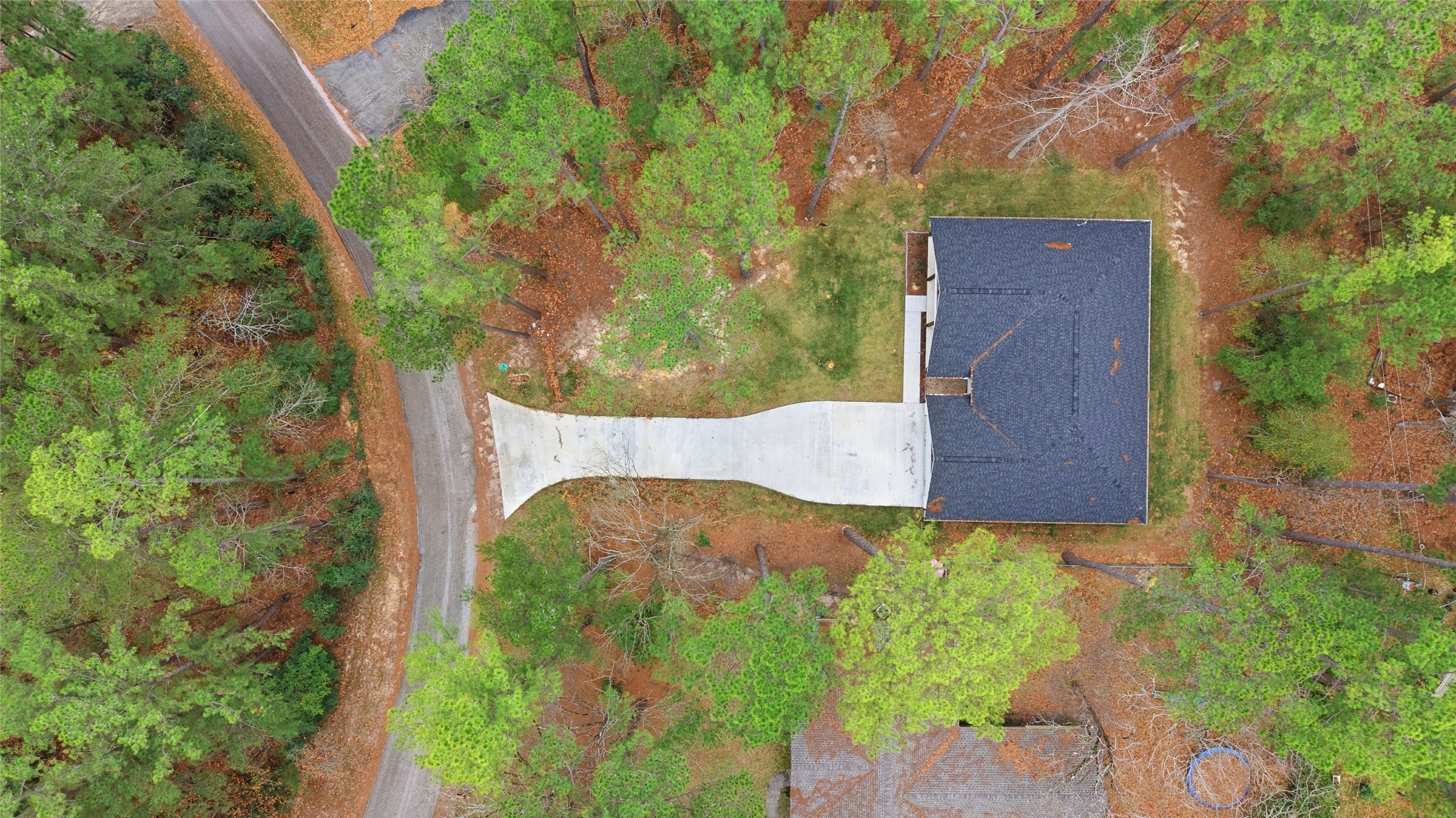 235 Dogwood Road Brookeland, TX 75931 - Photo 34 of 35 an aerial view of a house with a yard and large trees