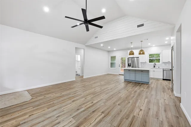 a view of a kitchen with a dishwasher and wooden floor