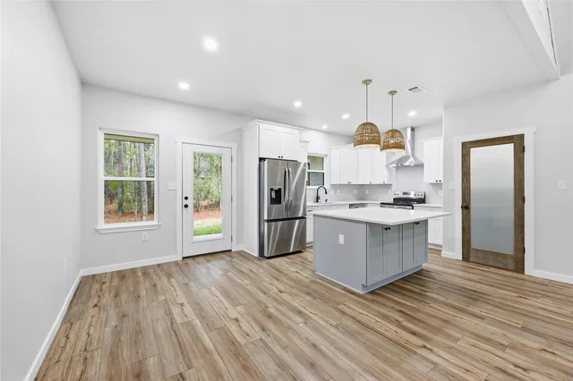 a kitchen with a refrigerator a sink and a stove