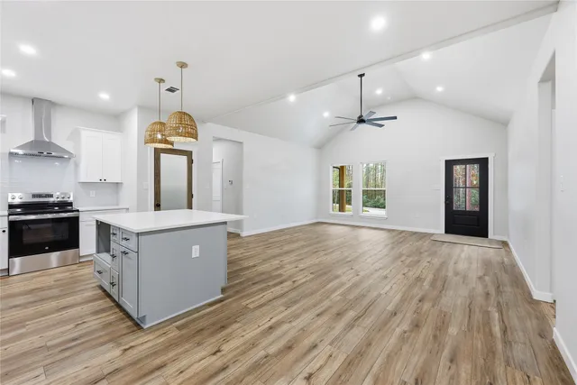 a kitchen with granite countertop a stove sink and cabinets