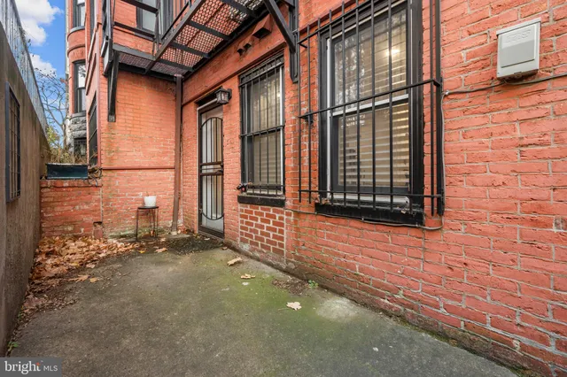a view of a brick house with an empty space
