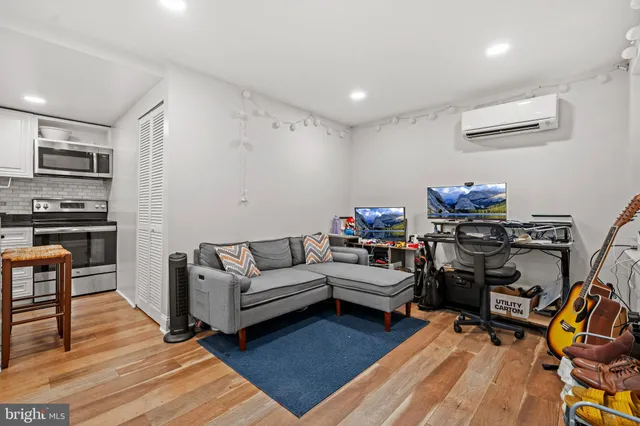 a living room with furniture and a wooden floor