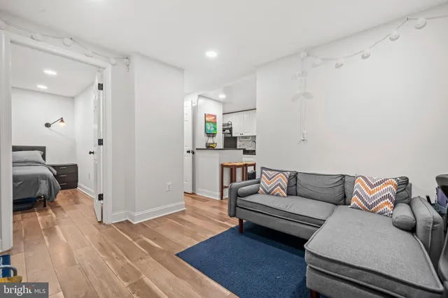 a living room with furniture and a wooden floor