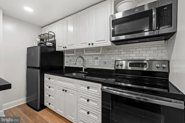 a kitchen with granite countertop cabinets and steel stainless steel appliances
