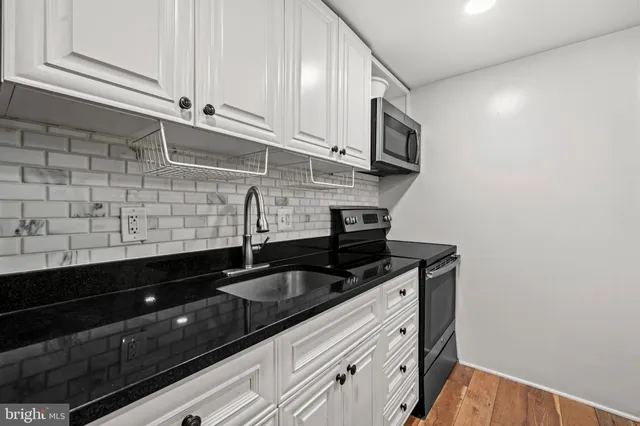 a kitchen with stainless steel appliances granite countertop a sink and a granite counter tops