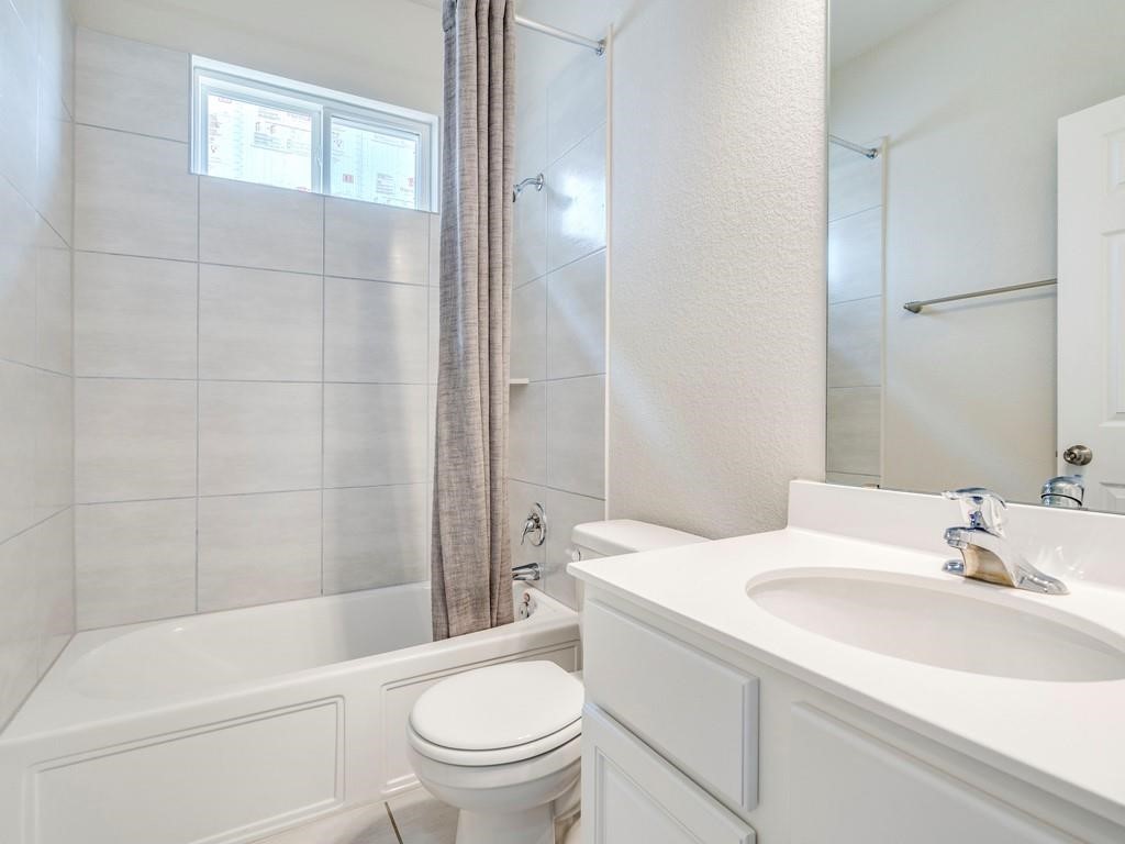 4210 Birdwatch Loop, Unit 2 Pflugerville, TX 78660 - Photo 20 of 31 A pristine bath features modern tile work and ample light from a transom window.