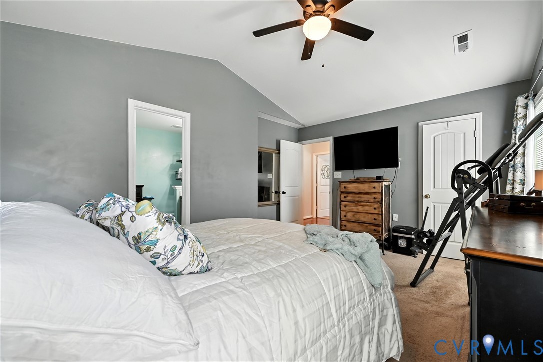 14006 Hackberry Road Chester, VA 23836 - Photo 23 of 41 a bedroom with a bed and a flat tv screen on the dresser