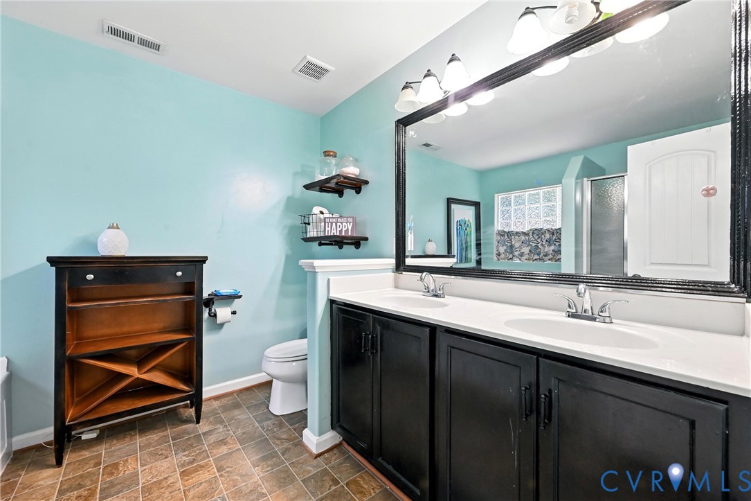14006 Hackberry Road Chester, VA 23836 - Photo 24 of 41 a bathroom with a sink mirror and toilet