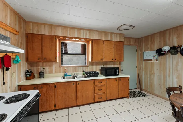 a kitchen with a sink stove and cabinets