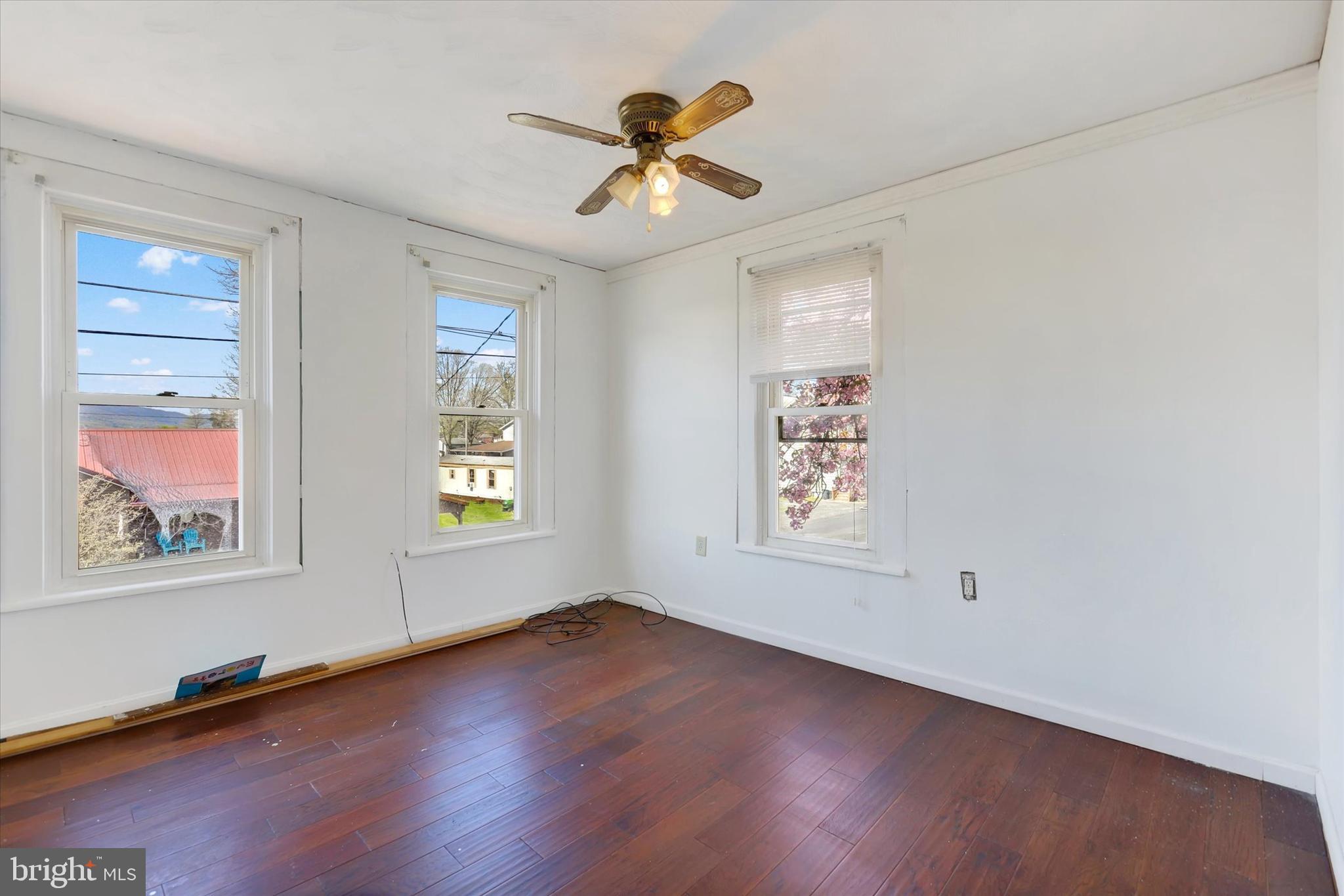 1435 Orchard Road Mifflinburg, PA 17844 - Photo 6 of 16 an empty room with window and wooden floor
