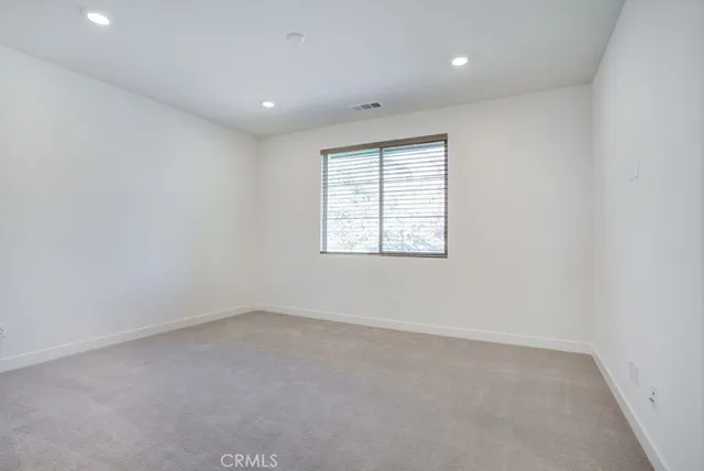 an empty room with a empty space and windows