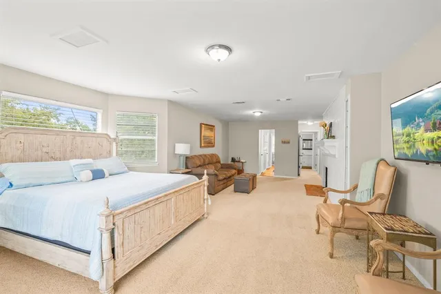 a bed room with a bed and large window