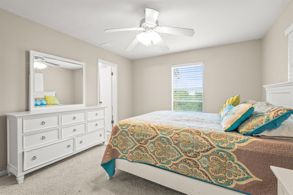 664 Lake Point Loop Pottsboro, TX 75076 - Photo 21 of 40 a bedroom with a bed a dresser and a window