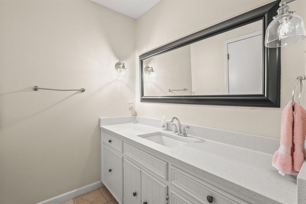 664 Lake Point Loop Pottsboro, TX 75076 - Photo 22 of 40 a bathroom with a sink and a mirror
