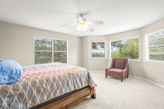 a bedroom with a bed chair and window