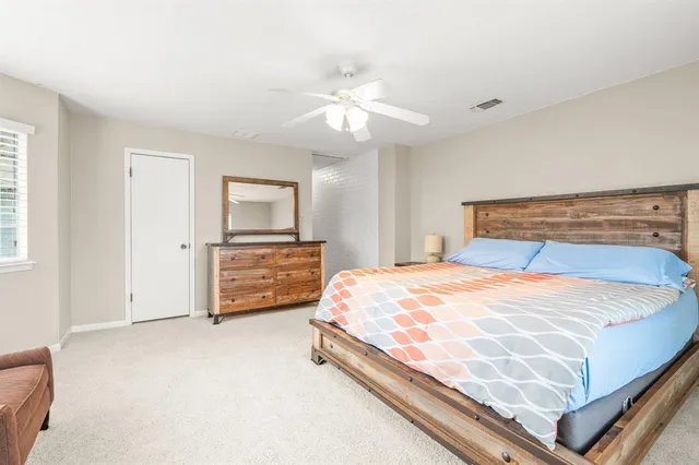 a bedroom with a bed and a tv on the dresser