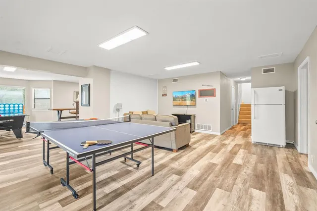 a room with table tennis and wooden floor