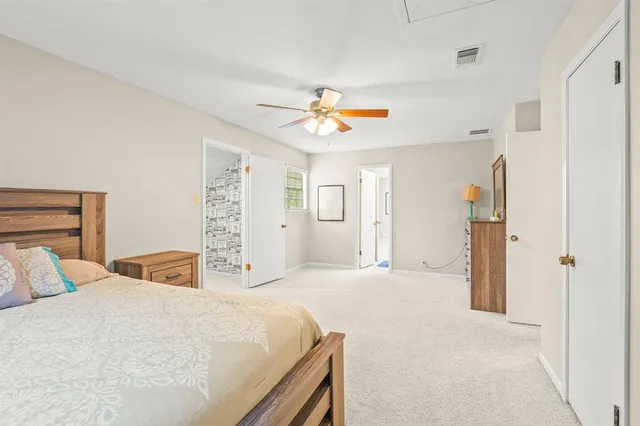 a bedroom with a large bed and a chandelier