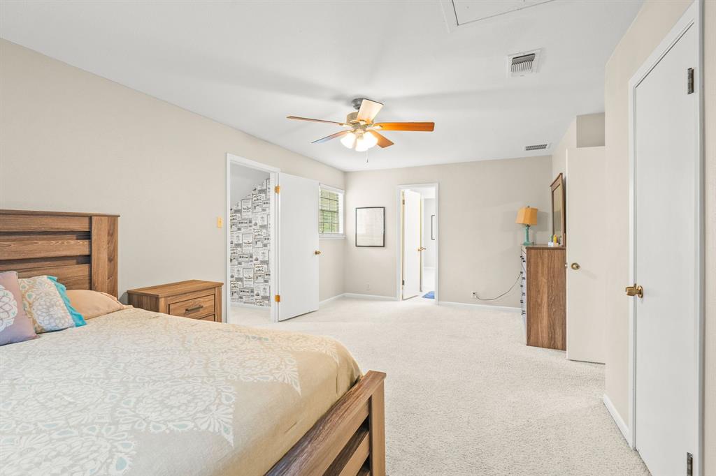 664 Lake Point Loop Pottsboro, TX 75076 - Photo 31 of 40 a bedroom with a large bed and a chandelier