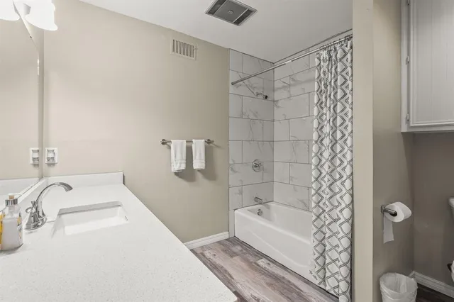 a bathroom with a bathtub and shower