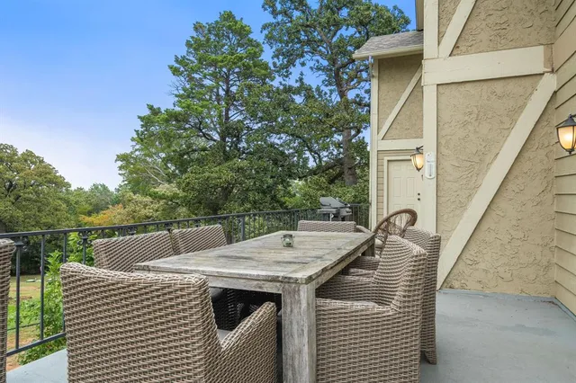a view of a balcony with table and chairs