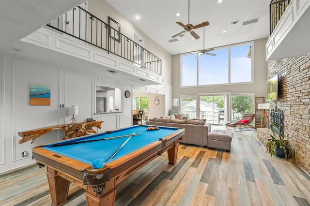 a living room with pool table and a fireplace