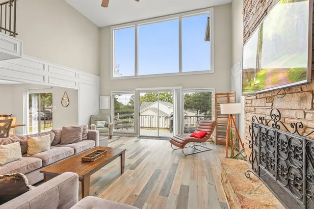 a living room filled with furniture and floor to ceiling windows