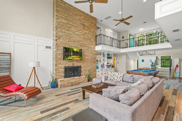 a living room with patio furniture and a fireplace