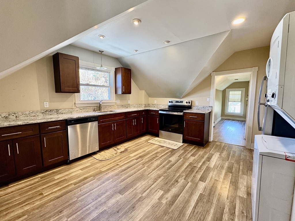 980 Washington Street, Unit 2 Stoughton, MA 02072 - Photo 1 of 10 a large kitchen with wooden floors and stainless steel appliances