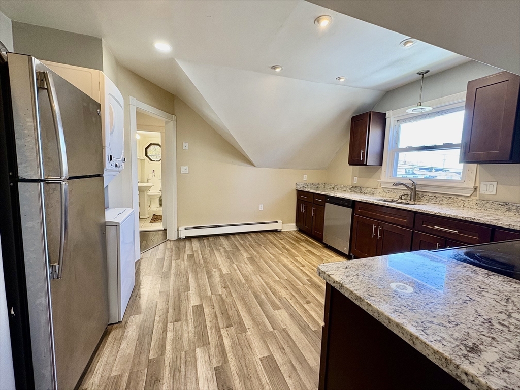 980 Washington Street, Unit 2 Stoughton, MA 02072 - Photo 2 of 10 a kitchen with stainless steel appliances granite countertop a sink and a refrigerator
