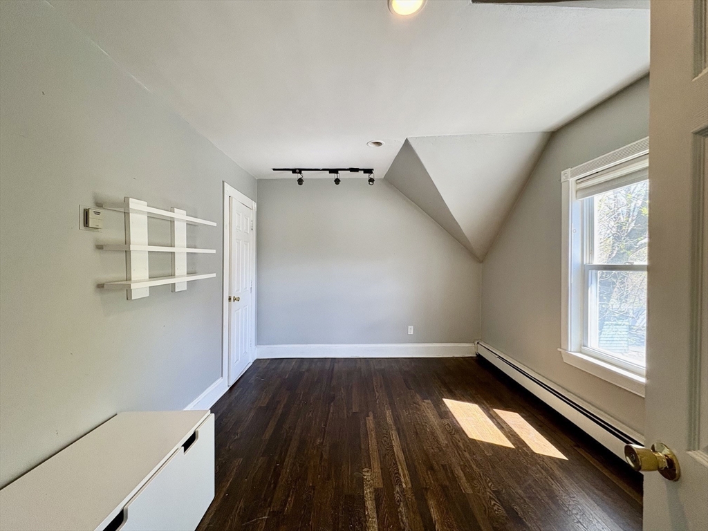 980 Washington Street, Unit 2 Stoughton, MA 02072 - Photo 6 of 10 wooden floor in an empty room with a window