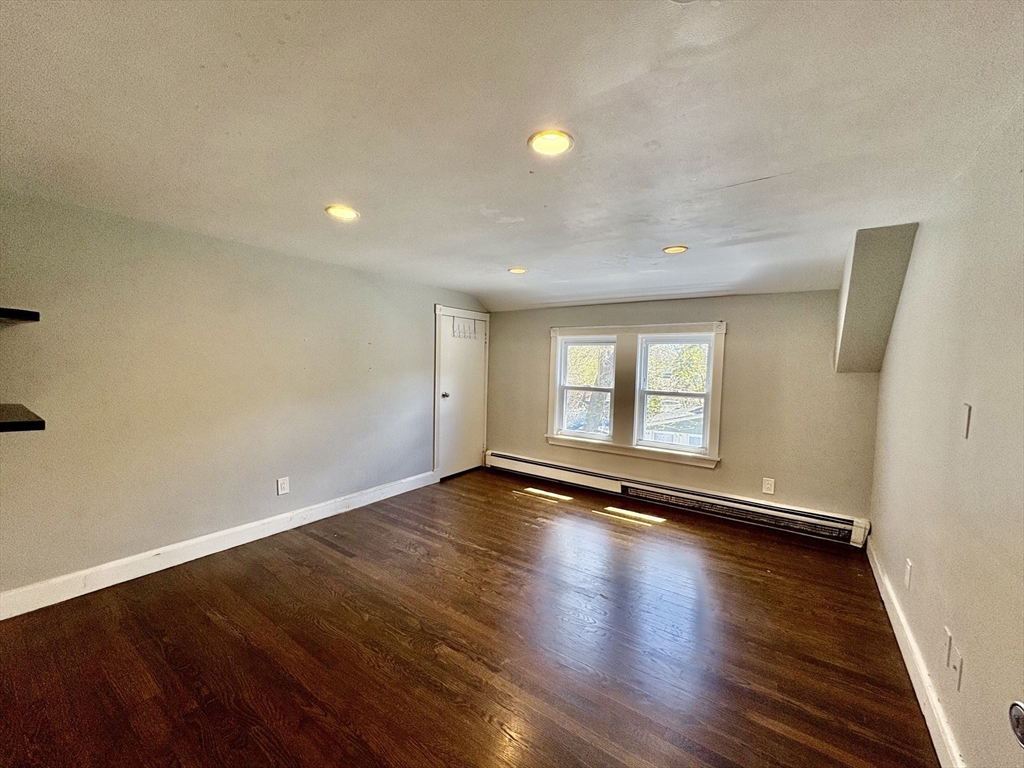 980 Washington Street, Unit 2 Stoughton, MA 02072 - Photo 7 of 10 a view of empty room with wooden floor and fan