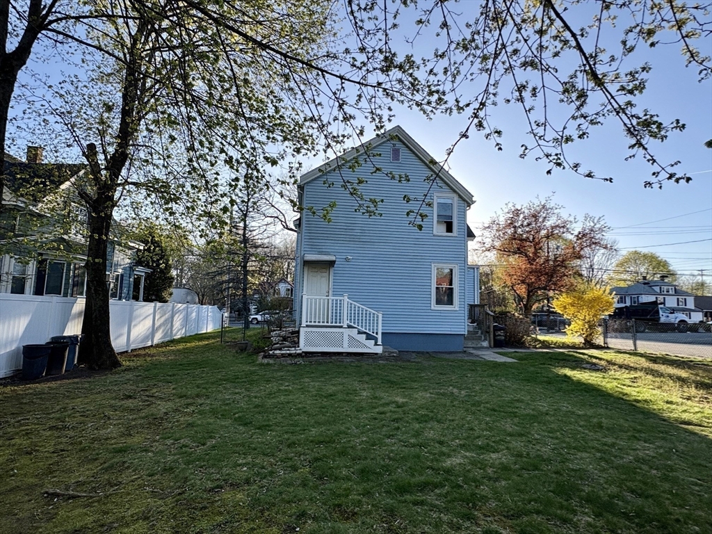 980 Washington Street, Unit 2 Stoughton, MA 02072 - Photo 8 of 10 a view of a house with a yard