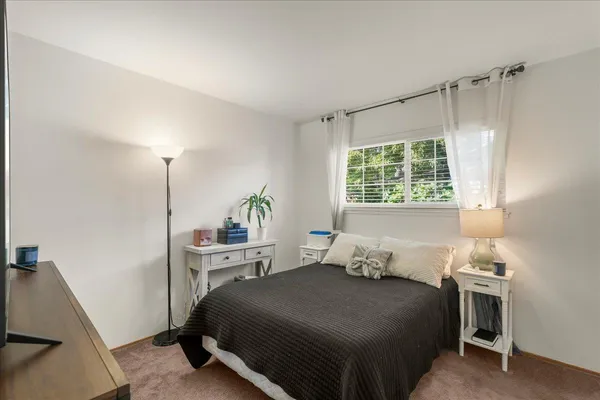 a bedroom with a bed and a window