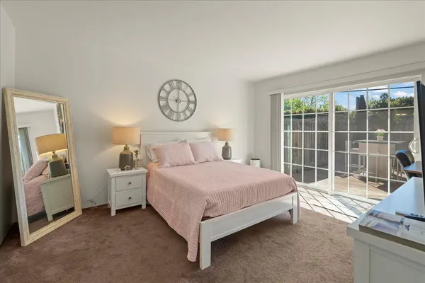 a spacious bedroom with a bed and a large window