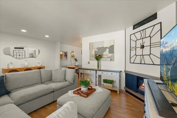 a living room with furniture and a wooden floor