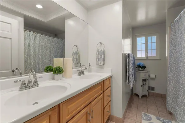 a bathroom with a double vanity sink and a mirror