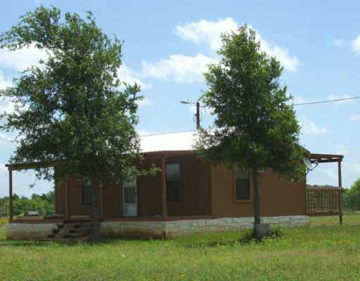 589 Upper Elgin River Road Elgin, TX 78621 - Photo 1 of 1 front view of house with a yard