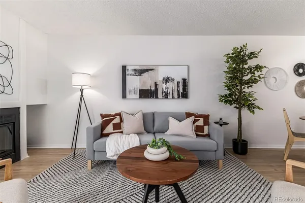 a living room with furniture and a potted plant