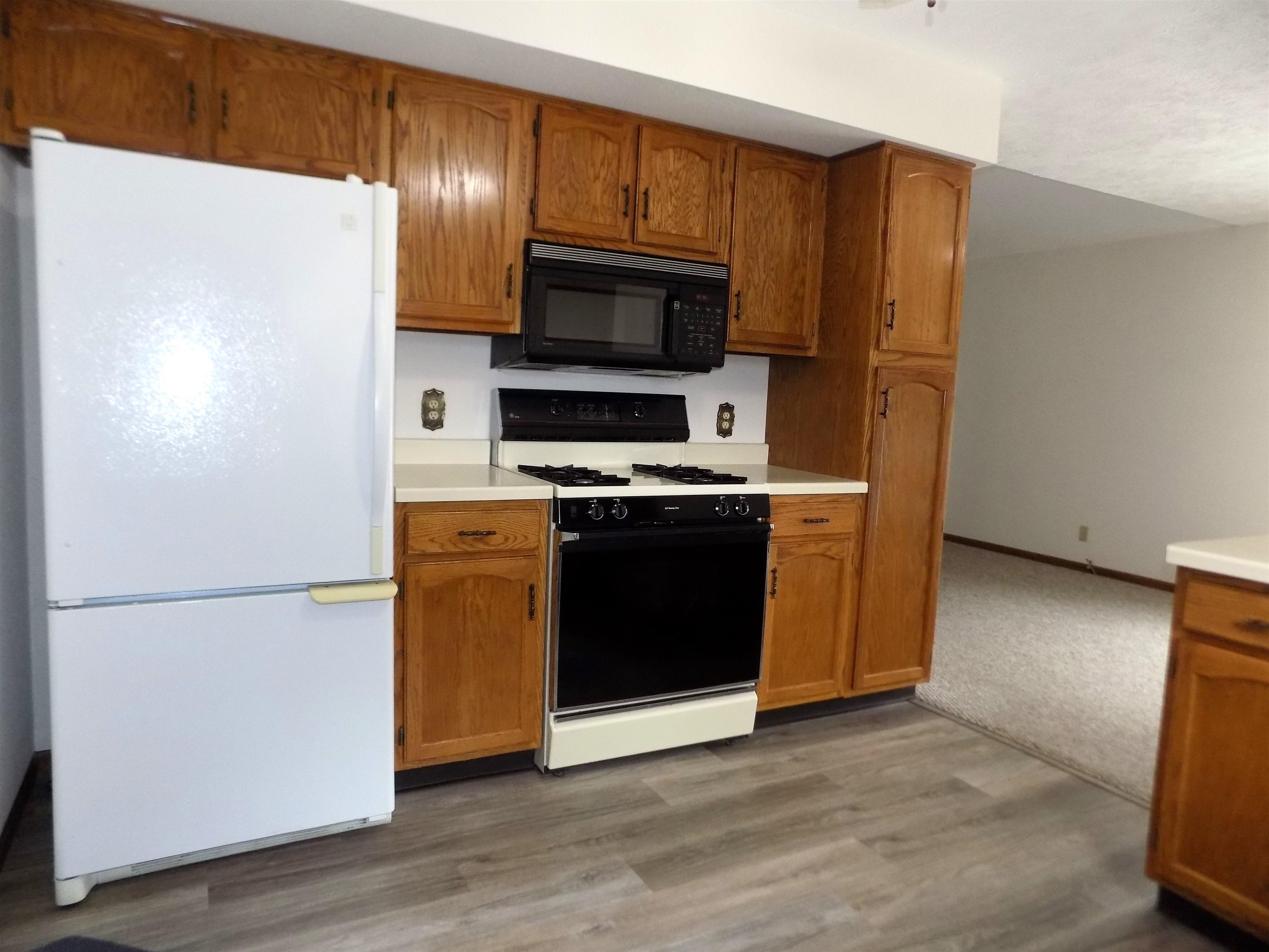 4252 Waltham Road Roscoe, IL 61073 - Photo 11 of 31 a kitchen with stainless steel appliances granite countertop a refrigerator microwave and sink
