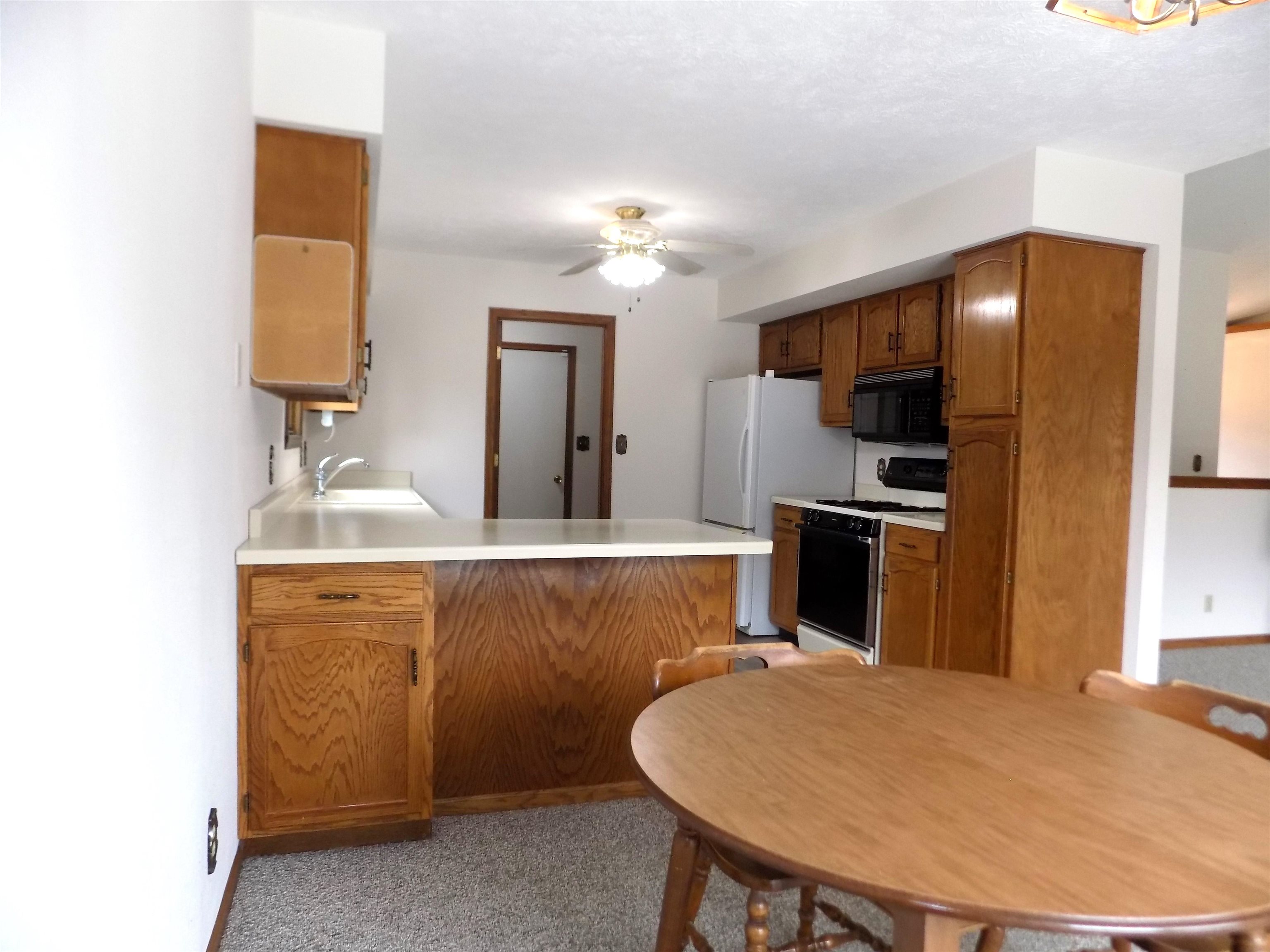 4252 Waltham Road Roscoe, IL 61073 - Photo 12 of 31 a kitchen with a sink cabinets and appliances