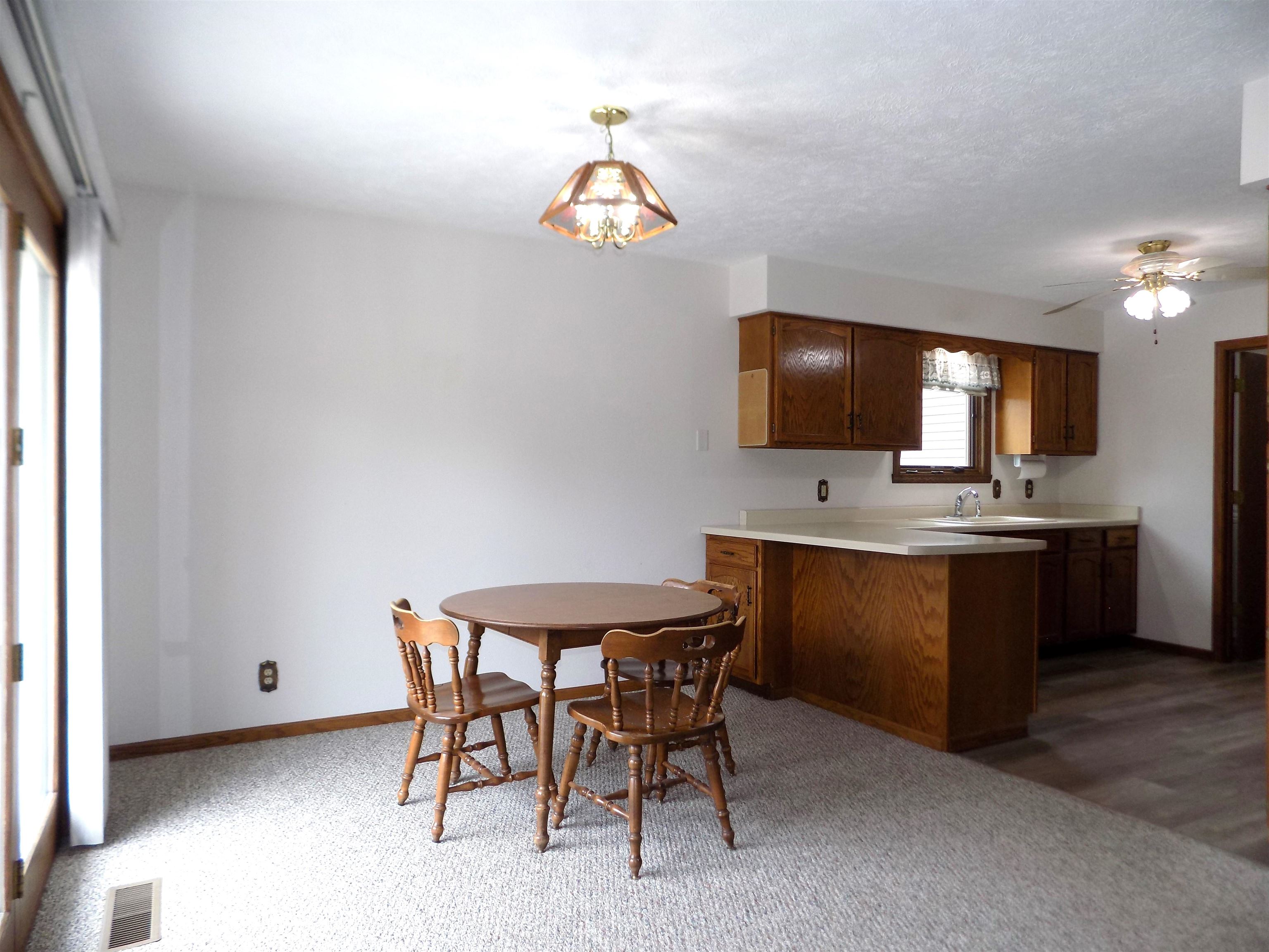 4252 Waltham Road Roscoe, IL 61073 - Photo 14 of 31 a view of a dining room with furniture and chandelier