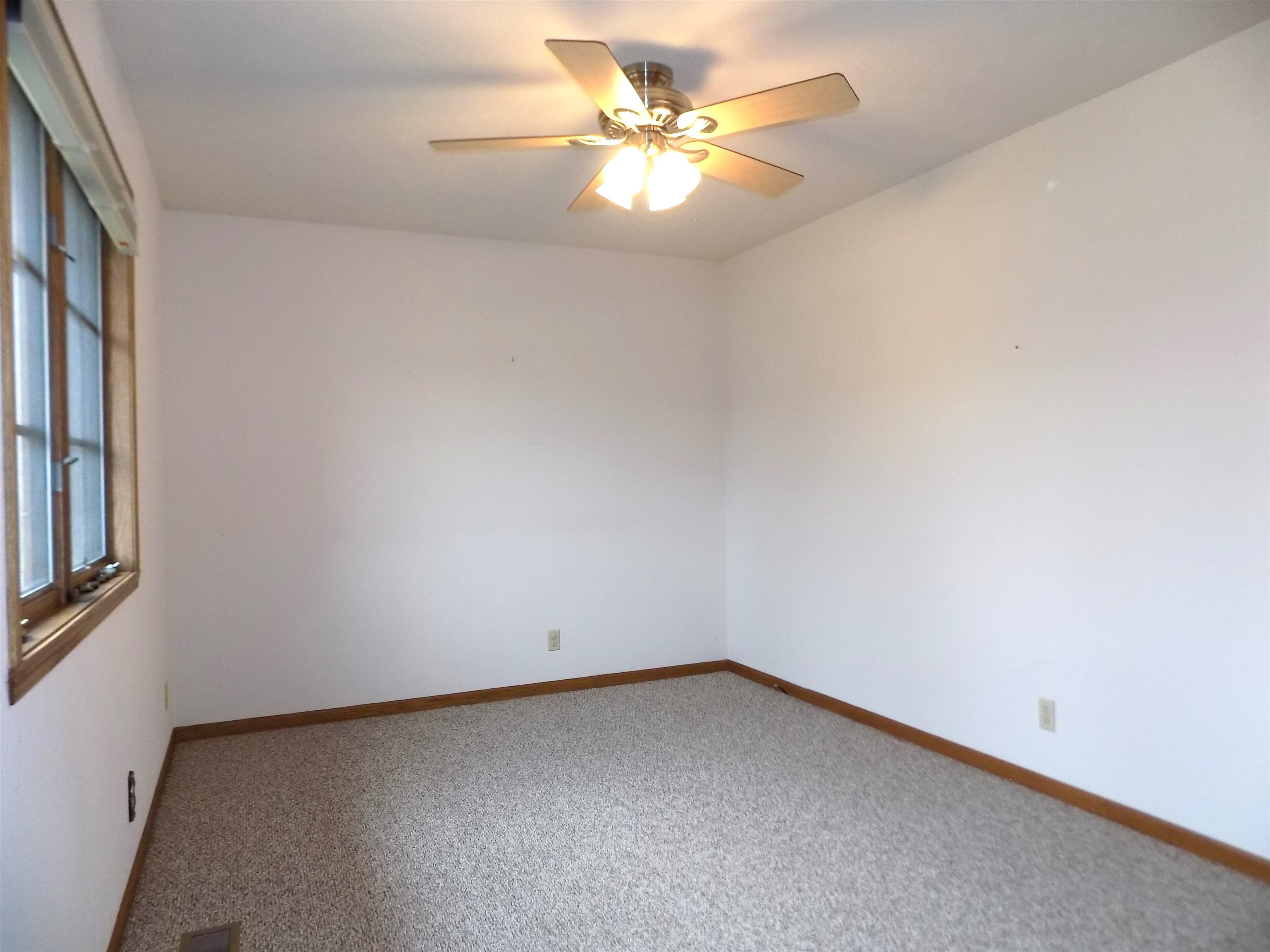 4252 Waltham Road Roscoe, IL 61073 - Photo 21 of 31 an empty room with a window and a ceiling fan