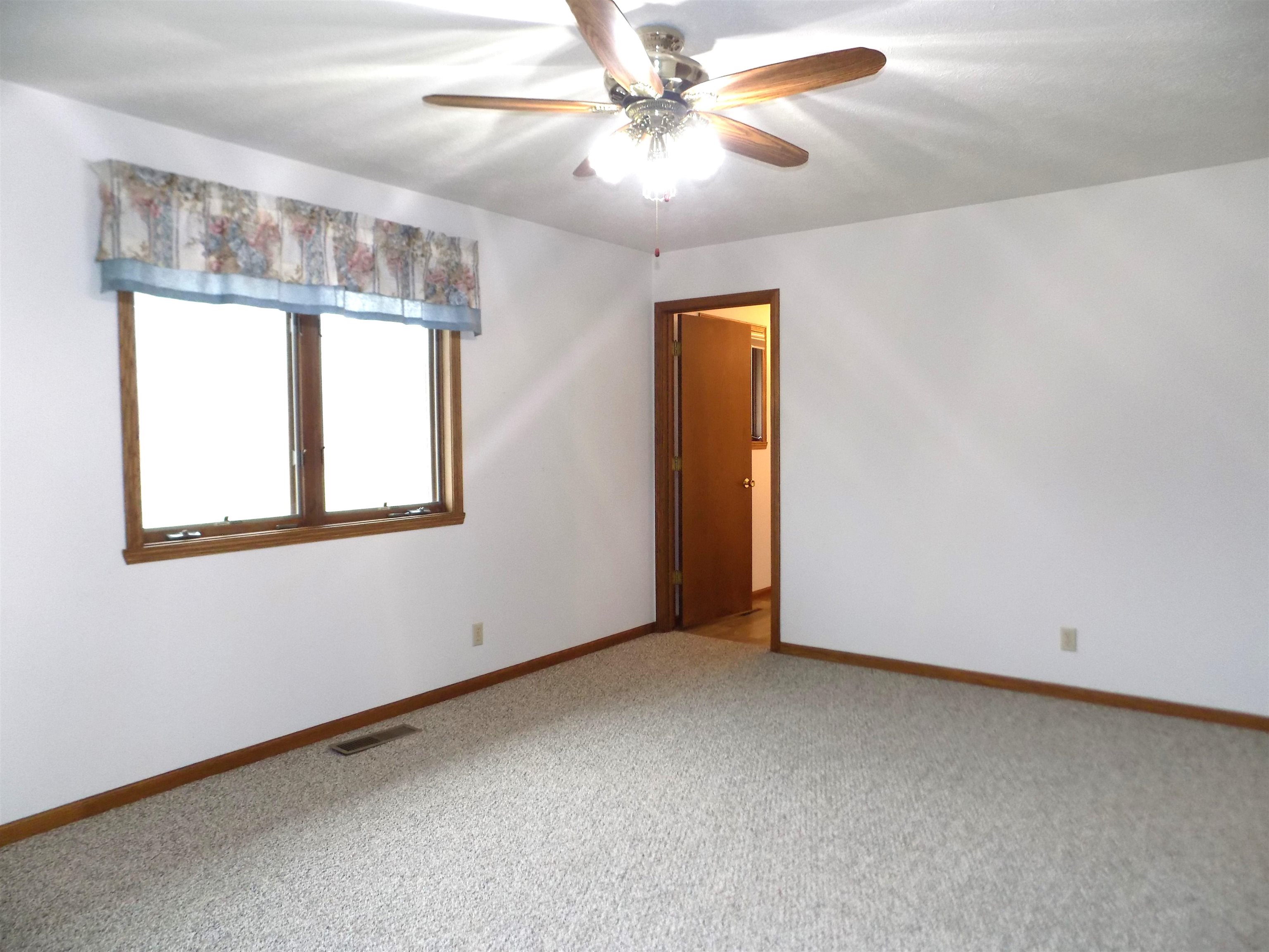 4252 Waltham Road Roscoe, IL 61073 - Photo 23 of 31 an empty room with windows and fan