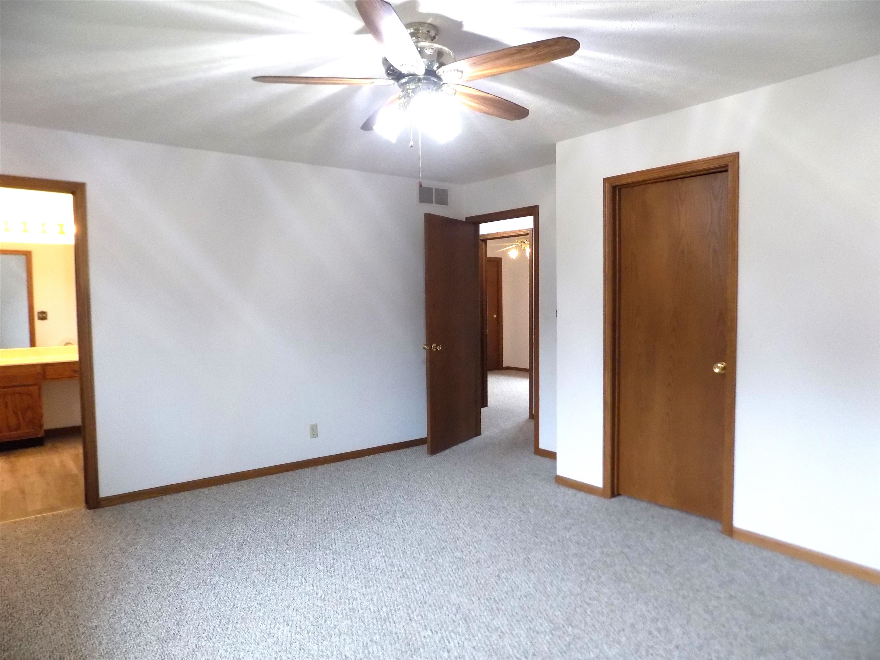 4252 Waltham Road Roscoe, IL 61073 - Photo 24 of 31 an empty room with closet and a ceiling fan