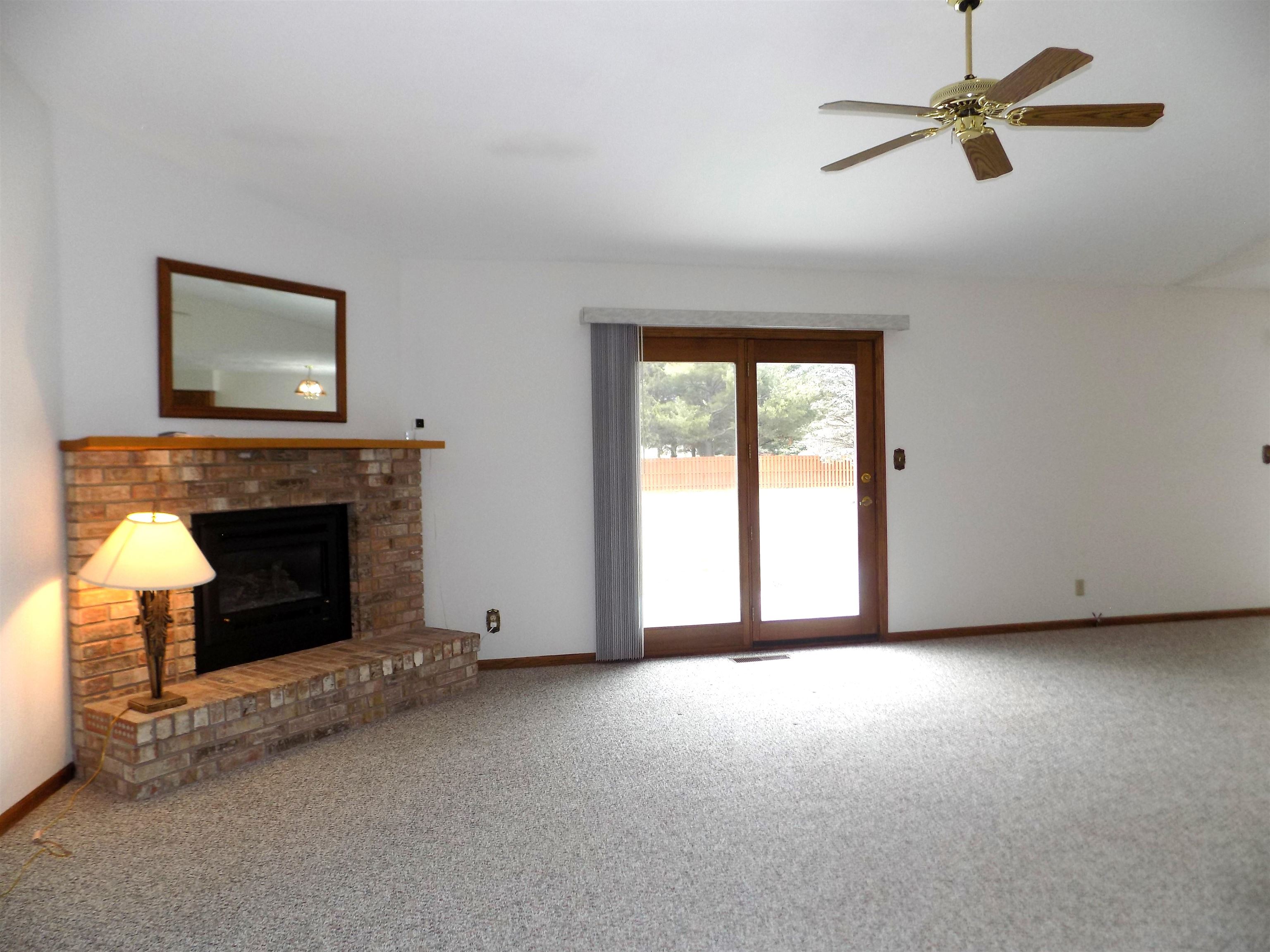4252 Waltham Road Roscoe, IL 61073 - Photo 5 of 31 a view of a livingroom with a fireplace and window
