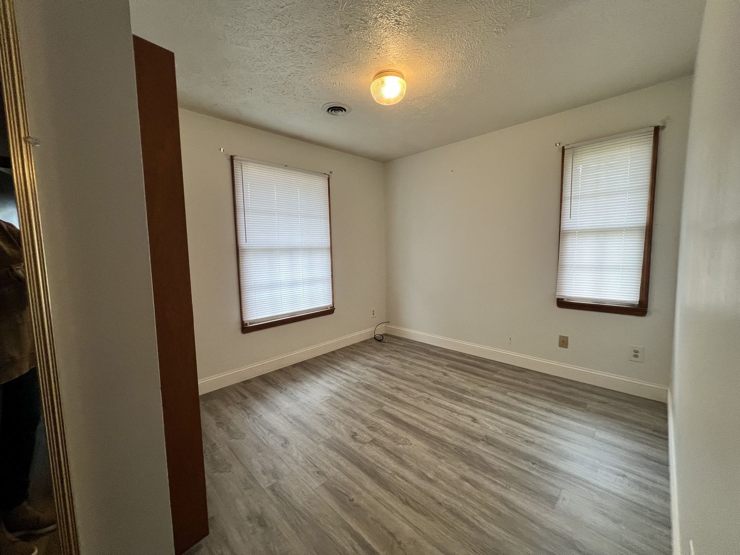 1525 Spruce Street Murphysboro, IL 62966 - Photo 13 of 13 an empty room with wooden floor cabinet and windows